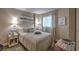 View of bedroom with queen bed and decorative pillows, matching bedside tables and beach themed decor at 2100 Sea Mountain Hwy. # 202, North Myrtle Beach, SC 29582
