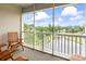 Screened balcony overlooking a pond and golf course, complete with wooden chairs at 2241 Waterview Dr. # 532, North Myrtle Beach, SC 29582