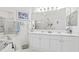 Bright bathroom featuring double sinks with a large mirror and white vanity with gold hardware at 2241 Waterview Dr. # 532, North Myrtle Beach, SC 29582