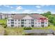 Exterior view of a condo building situated by a pond with a manicured lawn at 2241 Waterview Dr. # 532, North Myrtle Beach, SC 29582