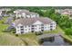 Aerial view of condo complex with a pond and surrounded by lush greenery at 2241 Waterview Dr. # 532, North Myrtle Beach, SC 29582
