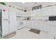 Well-lit kitchen with white cabinetry, appliances, tile floors, and decorative accents at 2241 Waterview Dr. # 532, North Myrtle Beach, SC 29582