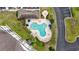 Aerial view of a community pool with seating, umbrellas, landscaping, and a clubhouse at 2241 Waterview Dr. # 532, North Myrtle Beach, SC 29582