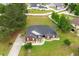 Aerial view of a brick home with manicured lawn, mature trees, and a long driveway at 249 Ashepoo Creek Dr., Myrtle Beach, SC 29579