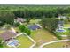 Aerial view of a home with a pool, landscaping, and a spacious yard surrounded by trees at 249 Ashepoo Creek Dr., Myrtle Beach, SC 29579
