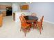 Charming dining area features a round table with four chairs and a view into the kitchen at 249 Ashepoo Creek Dr., Myrtle Beach, SC 29579