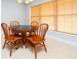 Cozy dining area features wood table and chairs and a large window for natural light at 249 Ashepoo Creek Dr., Myrtle Beach, SC 29579