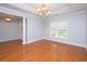 Bright dining room features hardwood floors and a modern chandelier at 249 Ashepoo Creek Dr., Myrtle Beach, SC 29579