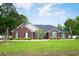 Inviting one-story brick home with a well-manicured lawn and mature landscaping at 249 Ashepoo Creek Dr., Myrtle Beach, SC 29579