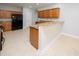 Bright kitchen featuring wood cabinetry, tile flooring, granite counters and bar with seating at 249 Ashepoo Creek Dr., Myrtle Beach, SC 29579