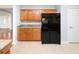 Kitchen boasts ample wood cabinetry, granite countertops, and black side-by-side refrigerator at 249 Ashepoo Creek Dr., Myrtle Beach, SC 29579