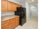 Kitchen features wood cabinets, granite countertops, and black refrigerator with water dispenser at 249 Ashepoo Creek Dr., Myrtle Beach, SC 29579