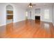 Open living room with hardwood floors, fireplace and arched doorway to kitchen at 249 Ashepoo Creek Dr., Myrtle Beach, SC 29579