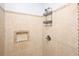 Shower stall boasts neutral tile, recessed shelf, and convenient shower caddy at 249 Ashepoo Creek Dr., Myrtle Beach, SC 29579
