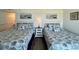 Relaxing bedroom has two twin beds, a shared nightstand, and stylish wall art at 2801 S Ocean Blvd. # 1041, North Myrtle Beach, SC 29582