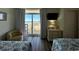 Inviting bedroom with two beds, a dresser, and sliding glass doors to a balcony at 2801 S Ocean Blvd. # 1041, North Myrtle Beach, SC 29582