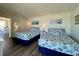 Bedroom featuring two beds, coastal decor, and a glimpse into the living area at 2801 S Ocean Blvd. # 1041, North Myrtle Beach, SC 29582