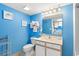 Bright bathroom with a toilet, vanity with mirror, and wall art, complemented by white fixtures at 2801 S Ocean Blvd. # 1634, North Myrtle Beach, SC 29582