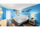 Cozy bedroom featuring a comfortable bed, a wooden nightstand, and stylish decorations on the blue wall at 2801 S Ocean Blvd. # 1634, North Myrtle Beach, SC 29582