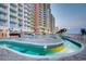 Beautiful lazy river pool with tile accents next to a condo building and the ocean at 2801 S Ocean Blvd. # 1634, North Myrtle Beach, SC 29582