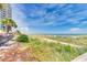 Beautiful beach view with clear skies, green vegetation, and blue ocean, promising a serene getaway at 3000 N Ocean Blvd. N # 129, Myrtle Beach, SC 29577