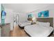 Comfortable bedroom featuring two beds, modern decor, and a calming ambiance with wood-look floors at 3000 N Ocean Blvd. N # 129, Myrtle Beach, SC 29577