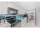 Modern kitchen with white cabinets, black appliances, and a bright view from the adjacent dining area at 3000 N Ocean Blvd. N # 129, Myrtle Beach, SC 29577