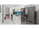 Modern kitchen with white cabinetry, stainless steel appliances, blue backsplash, and stylish countertops at 3000 N Ocean Blvd. N # 129, Myrtle Beach, SC 29577