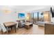 Comfortable living room with modern furnishings, a table with chairs, and a bright balcony with ocean views at 3000 N Ocean Blvd. N # 129, Myrtle Beach, SC 29577