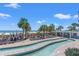 Beautiful resort pool with a beach bar, palm trees, lounge chairs, and a clear blue sky at 3000 N Ocean Blvd. N # 129, Myrtle Beach, SC 29577