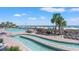 Resort pool area with lush palm trees, lounge chairs, and a beach view in the background at 3000 N Ocean Blvd. N # 129, Myrtle Beach, SC 29577