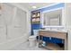 Clean bathroom featuring a shower and tub combination, a modern vanity, and blue wall accents at 3000 N Ocean Blvd. N # 1401, Myrtle Beach, SC 29577