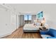 Bright bedroom featuring a king bed, blue accents, and a large window with city views at 3000 N Ocean Blvd. N # 1401, Myrtle Beach, SC 29577