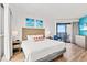 Cozy bedroom featuring a king bed, ocean-themed artwork, and a sliding glass door with a balcony at 3000 N Ocean Blvd. N # 1401, Myrtle Beach, SC 29577