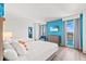 Bright bedroom featuring two queen beds, a TV, blue accent wall, and large windows at 3000 N Ocean Blvd. N # 1401, Myrtle Beach, SC 29577