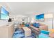 Open-concept living room with a comfortable sofa, modern furnishings, and a large television at 3000 N Ocean Blvd. N # 1401, Myrtle Beach, SC 29577