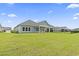 Expansive backyard with well-maintained lawn, patio and a black metal fence at 3021 Sistine St., Myrtle Beach, SC 29579