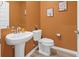 Cozy bathroom with pedestal sink, matching toilet and neutral wall color at 3021 Sistine St., Myrtle Beach, SC 29579