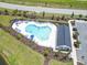 Aerial view of a community pool with lounge chairs, umbrellas and a covered picnic area at 3021 Sistine St., Myrtle Beach, SC 29579