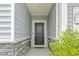 Inviting front entrance with a classic black door framed by white columns and stone accents at 3021 Sistine St., Myrtle Beach, SC 29579
