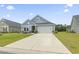 Well-manicured home with blue siding, black door and a spacious driveway at 3021 Sistine St., Myrtle Beach, SC 29579