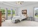 Bright main bedroom with tray ceiling, large windows, and neutral decor at 3021 Sistine St., Myrtle Beach, SC 29579