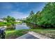 Backyard view looking onto a pond surrounded by lush trees and greenery at 3120 Mercer Dr., Conway, SC 29526