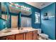 Cozy bathroom with bright blue walls, framed mirror, and wood-look vanity at 3120 Mercer Dr., Conway, SC 29526