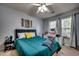 Bright bedroom featuring a comfortable bed, stylish decor, ceiling fan, and vanity with ample natural light at 3120 Mercer Dr., Conway, SC 29526