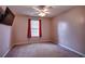 Bedroom featuring neutral-colored walls, a ceiling fan, and a window with red curtains at 3120 Mercer Dr., Conway, SC 29526