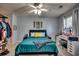 Comfortable bedroom with a cozy bed, stylish decor, ceiling fan, and a vanity area with ample lighting at 3120 Mercer Dr., Conway, SC 29526