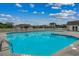 A stunning community pool with clear blue water, bordered by a white fence and neighborhood homes at 3120 Mercer Dr., Conway, SC 29526