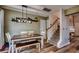 Dining room with dark wood table, bench seating, wood grain floors and modern chandelier at 3120 Mercer Dr., Conway, SC 29526