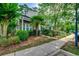 Two-story townhouse featuring a charming yard with a small palm tree and green shrubs at 3120 Mercer Dr., Conway, SC 29526